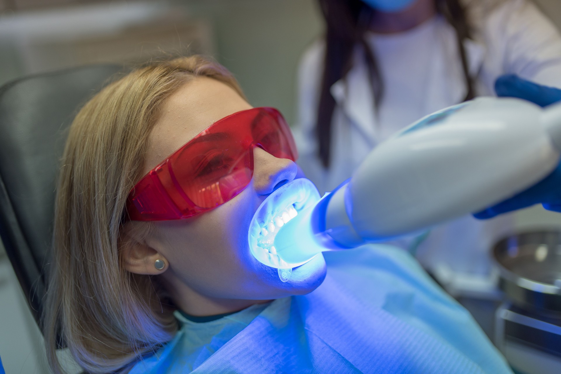 Woman getting laser teeth whitening